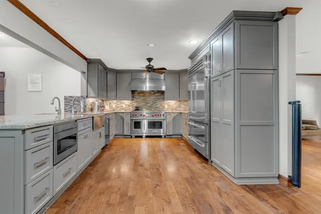 a kitchen with stainless steel appliances a refrigerator sink and cabinets