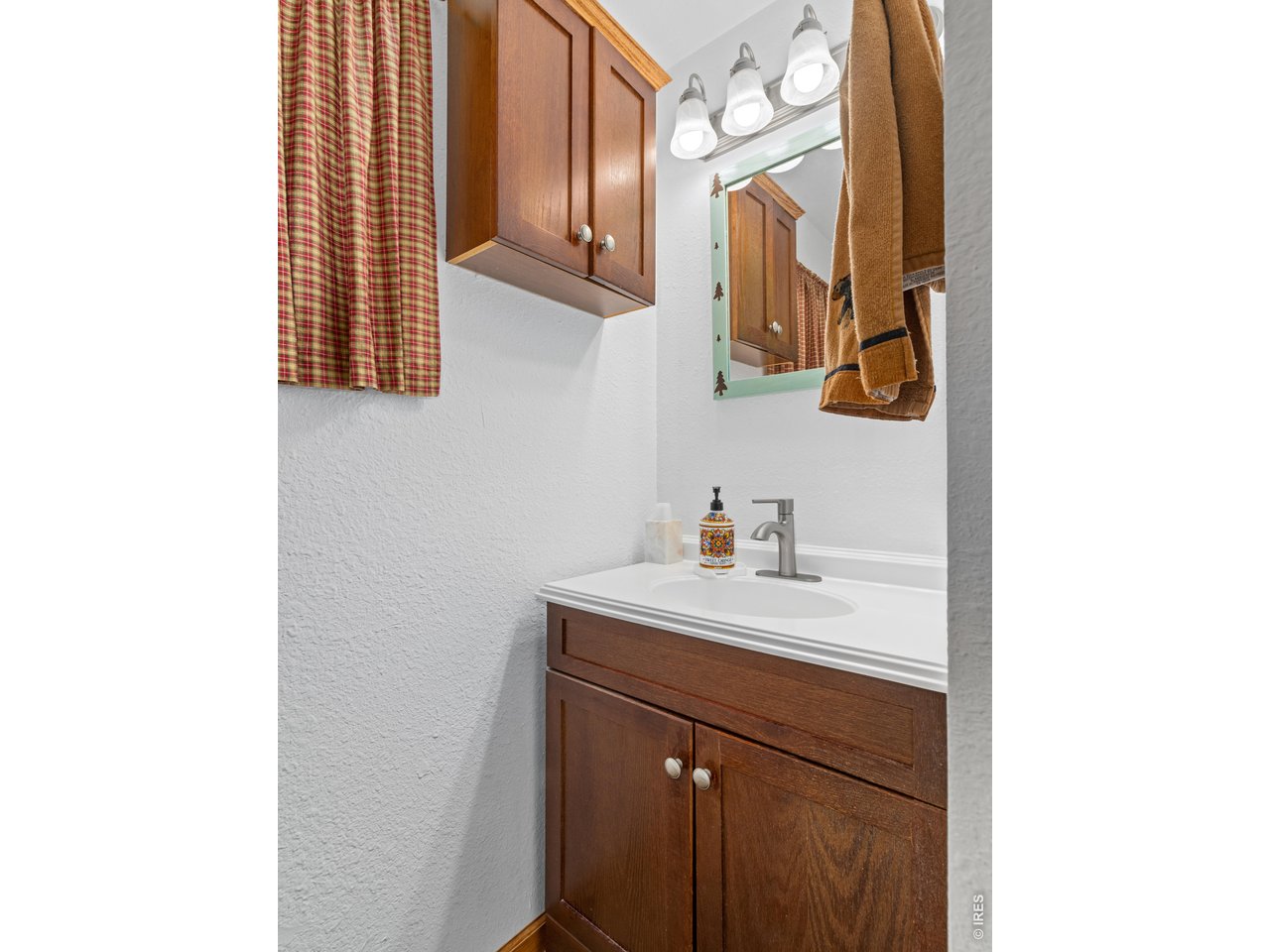 1002 Streamside Drive Drake, CO 80515 - Photo 11 of 37 a bathroom with a sink and a mirror