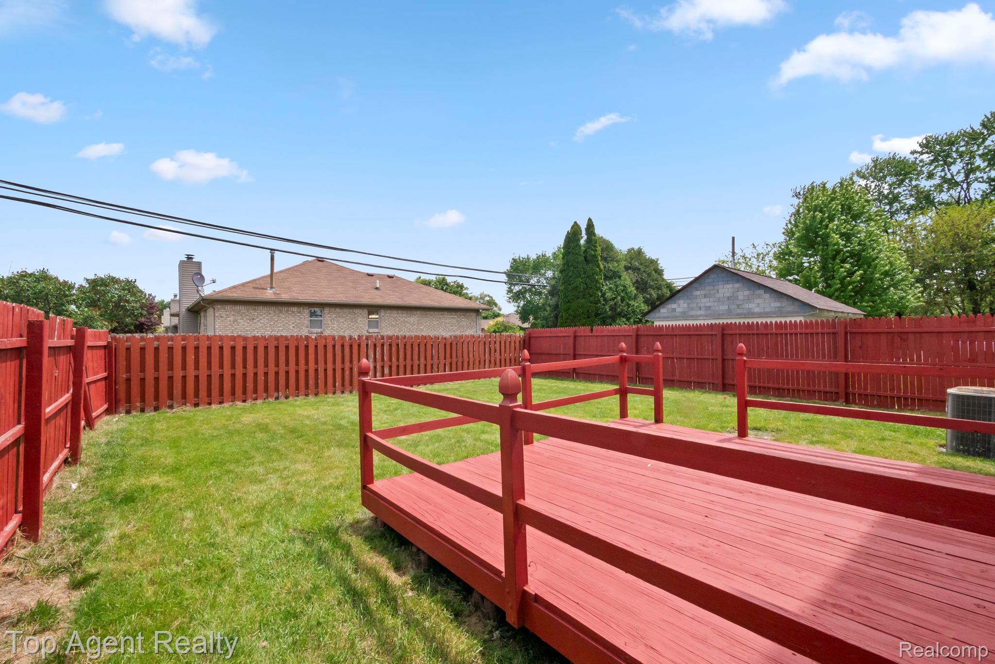 2018 John R Road Troy, MI 48083 - Photo 27 of 30 Fenced backyard with a wooden deck