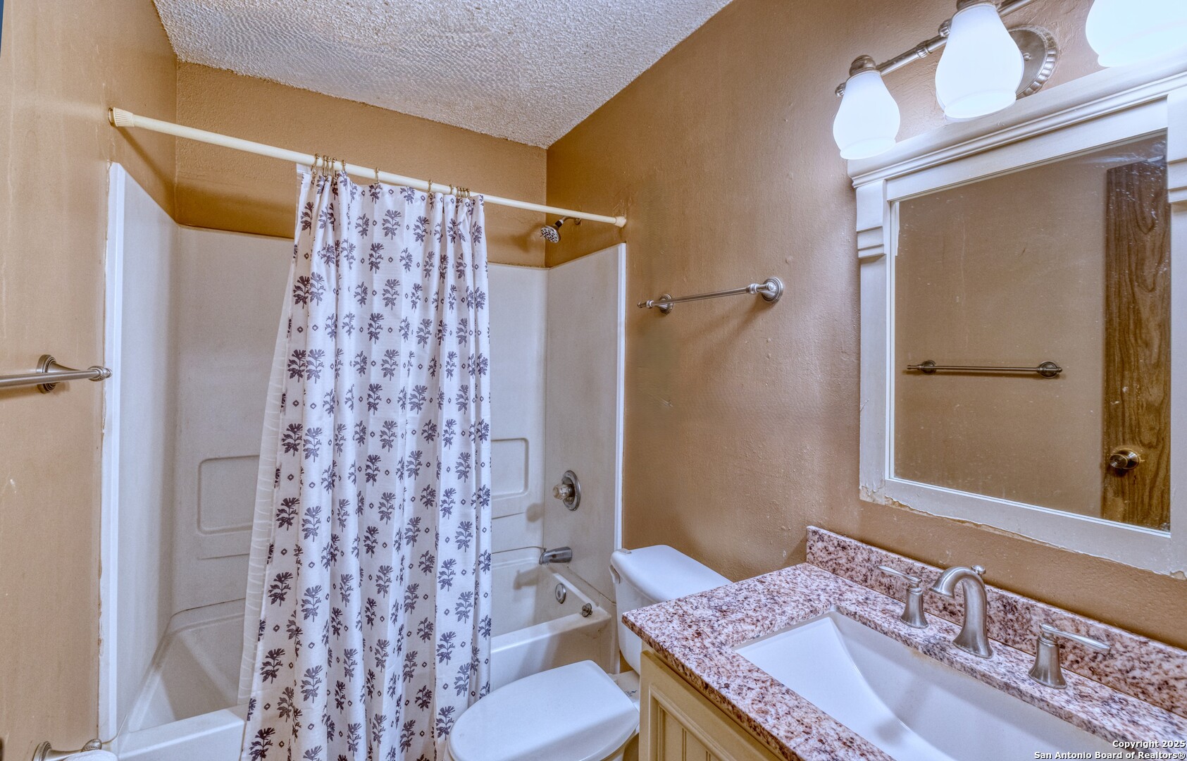 313 Bohme Street Uvalde, TX 78801 - Photo 11 of 23 a bathroom with a granite countertop sink toilet and shower