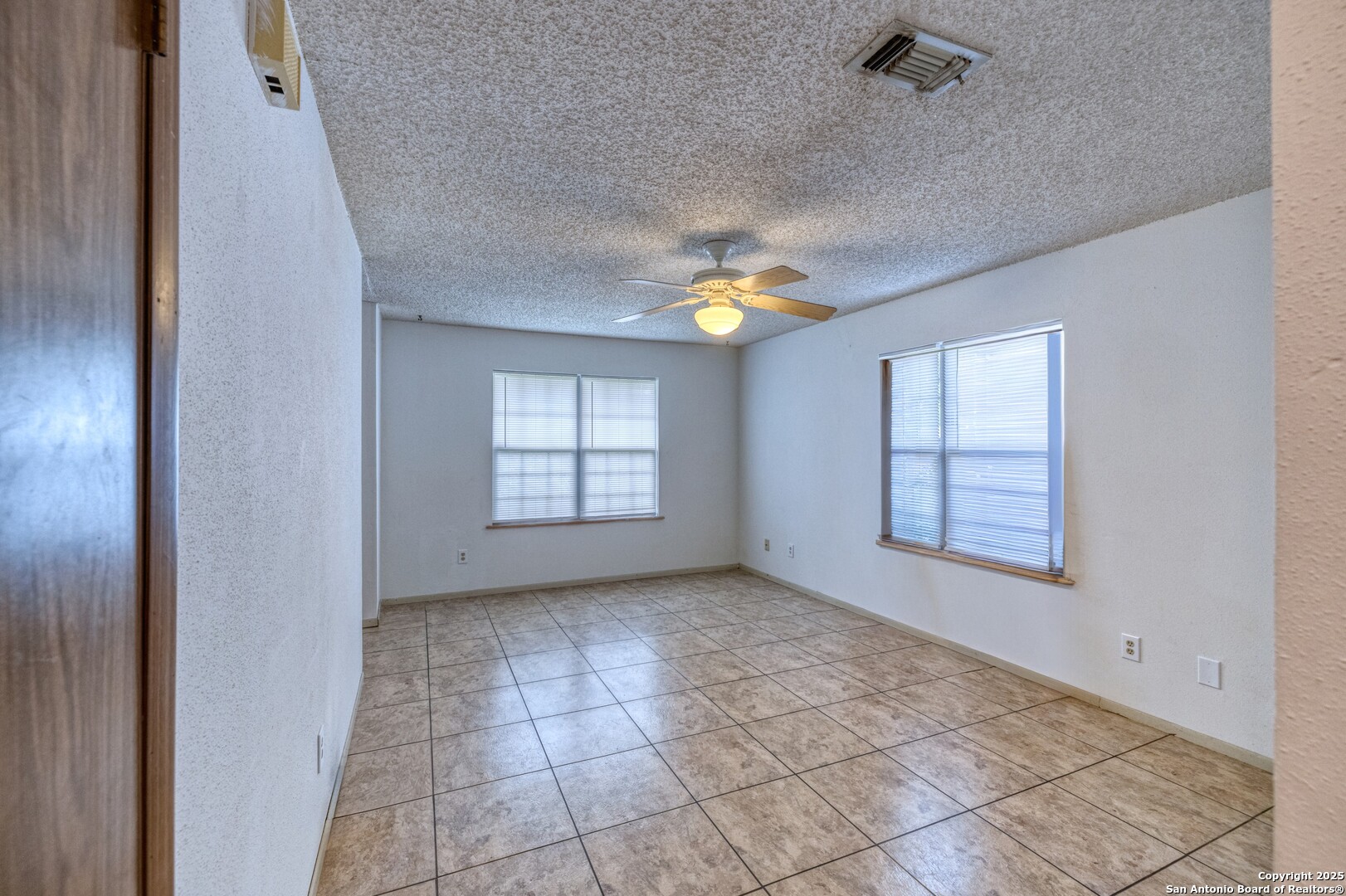 313 Bohme Street Uvalde, TX 78801 - Photo 5 of 23 an empty room with windows