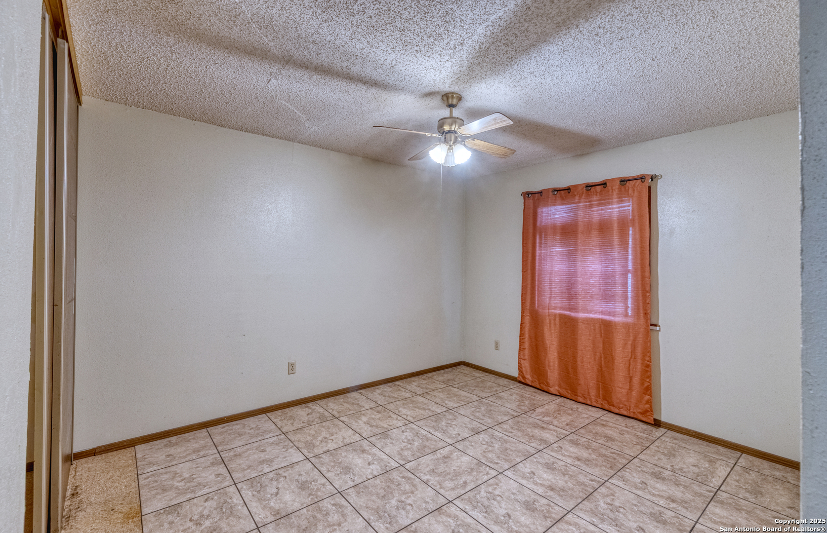 313 Bohme Street Uvalde, TX 78801 - Photo 10 of 23 an empty room with windows and fan