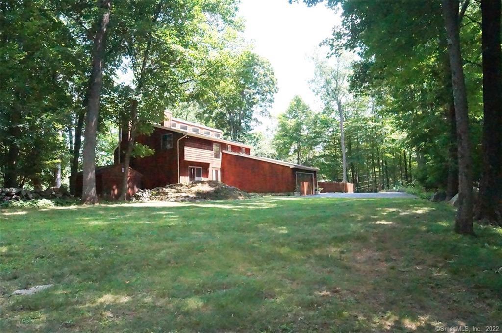 328 Mountain Road Ridgefield, CT 06877 - Photo 1 of 1 a view of a backyard with large trees and plants
