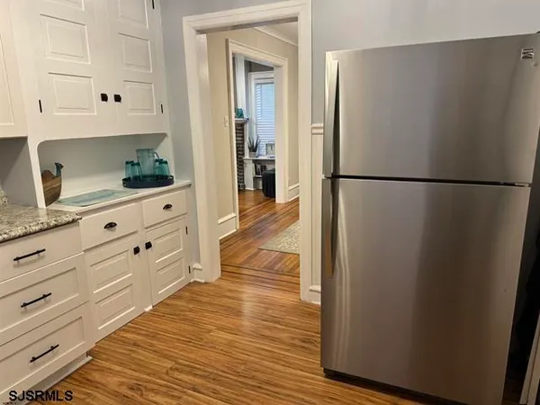 a view of a kitchen with refrigerator and cabinet