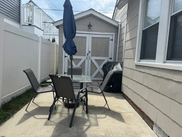 a view of a patio with table and chairs and wooden floor
