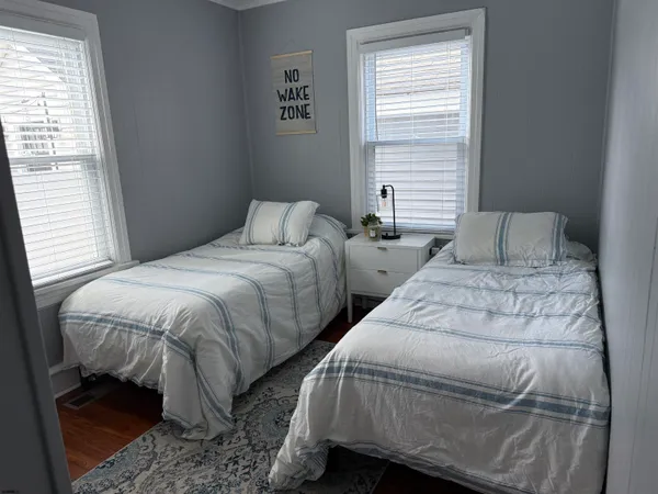 a bedroom with two beds and a window