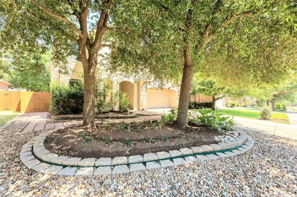 a view of a backyard with large trees
