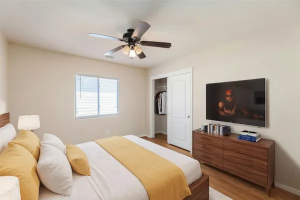 a bedroom with a bed and a flat screen tv