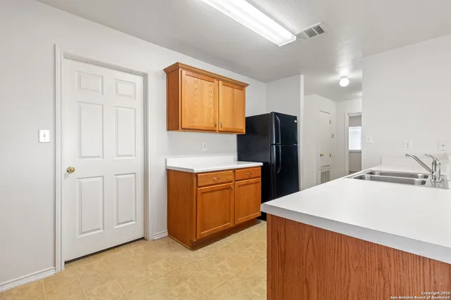 a kitchen with a refrigerator and cabinets