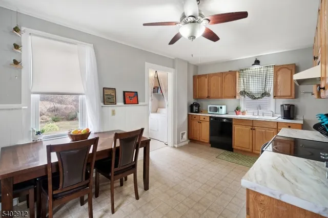 a kitchen with a table chairs and a refrigerator