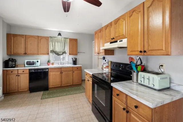 a kitchen with a stove sink and cabinets