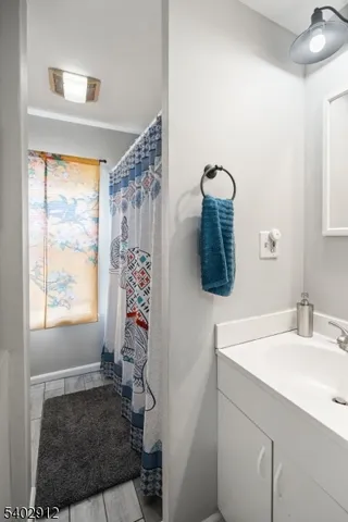 a bathroom with a sink a mirror and window
