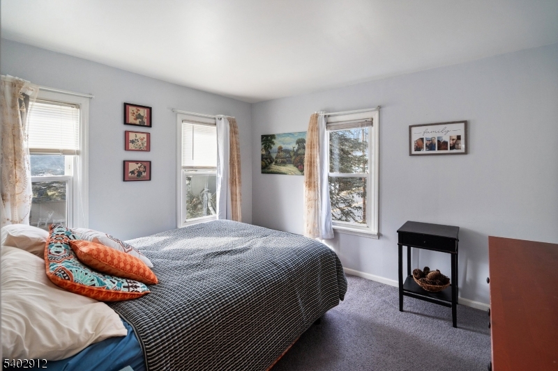 89 Trinity Street Newton, NJ 07860 - Photo 16 of 21 a bedroom with a bed a dresser and next to a window