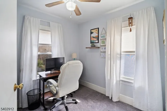 a view of workspace with wooden floor windows