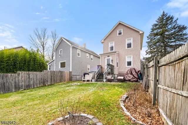 a front view of house with patio and yard