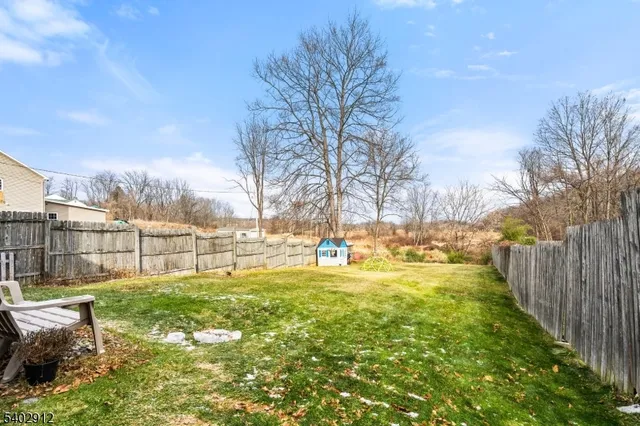 a view of a backyard with wooden fence