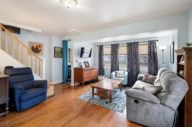 a living room with furniture and large windows