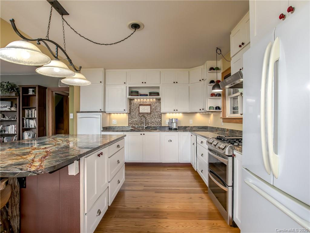 390 Grandview Road Canton, NC 28716 - Photo 13 of 42 a kitchen with stainless steel appliances granite countertop a stove a sink and a refrigerator