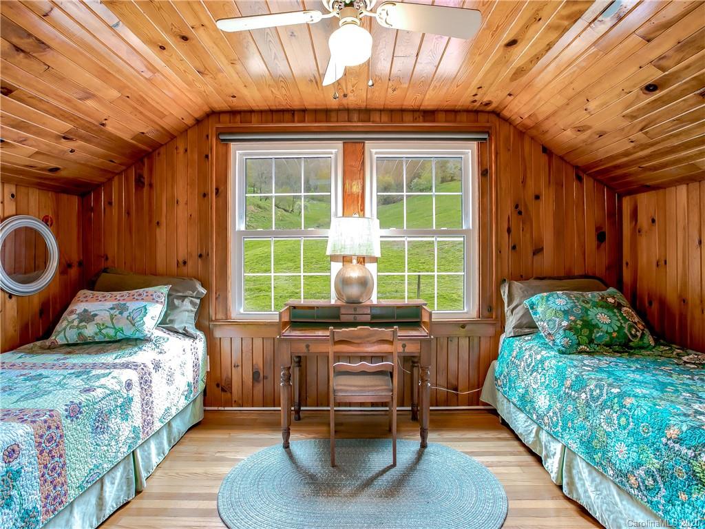 390 Grandview Road Canton, NC 28716 - Photo 23 of 42 a bedroom with a bed and windows
