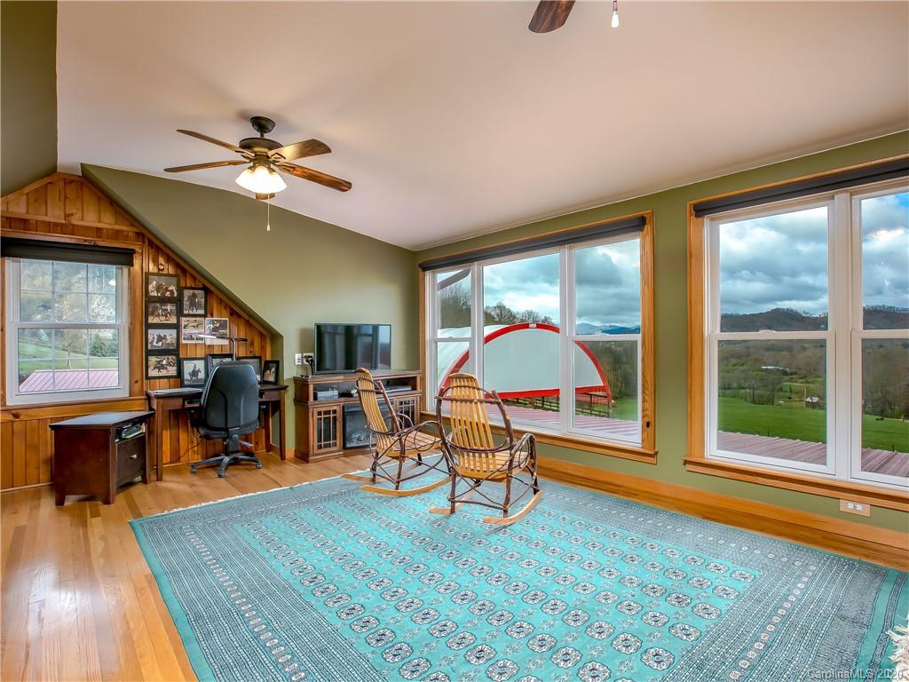 390 Grandview Road Canton, NC 28716 - Photo 24 of 42 a view of a livingroom with furniture wooden floor windows and a chandelier