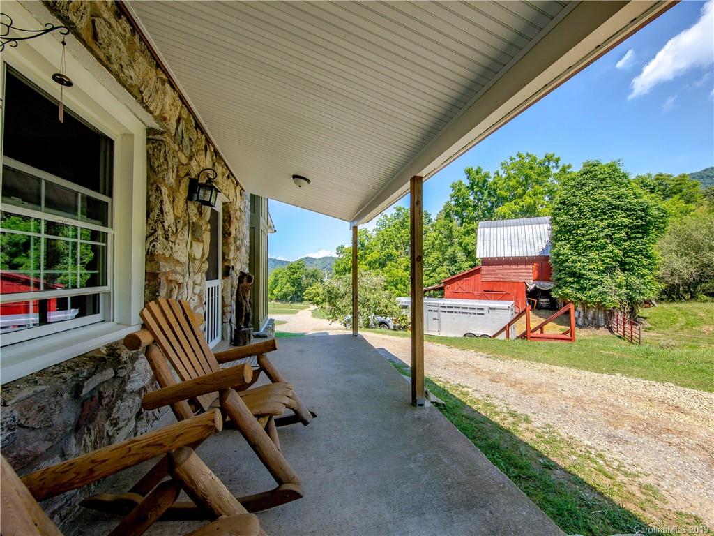 390 Grandview Road Canton, NC 28716 - Photo 7 of 42 a view of a porch with furniture and floor to ceiling window