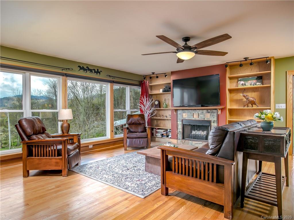390 Grandview Road Canton, NC 28716 - Photo 9 of 42 a living room with furniture and a flat screen tv with wooden floor