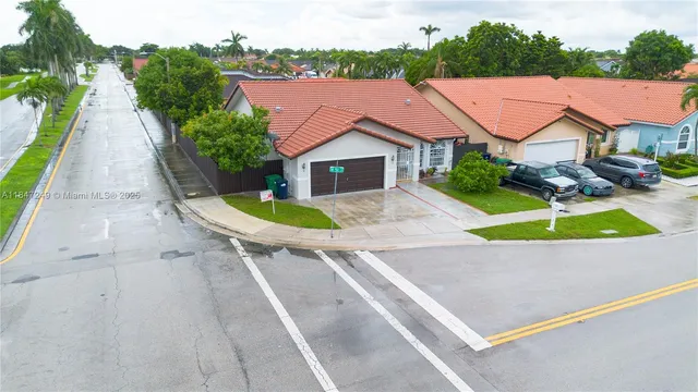 an aerial view of a house with swimming pool and porch