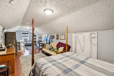 a bed room with a bed and a flat screen tv