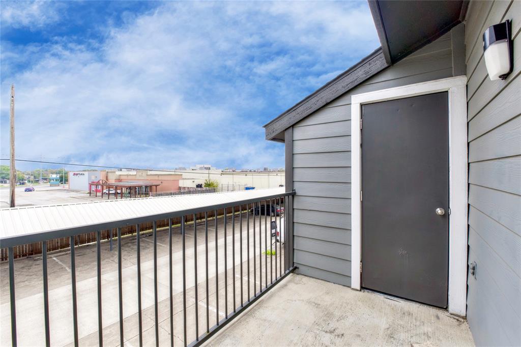 9696 Walnut Street, Unit 312 Dallas, TX 75243 - Photo 14 of 29 a view of a balcony with wooden fence