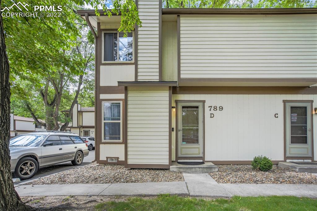 789 Alexander Road, Unit D Colorado Springs, CO 80909 - Photo 1 of 36 a view of a car in front of a house