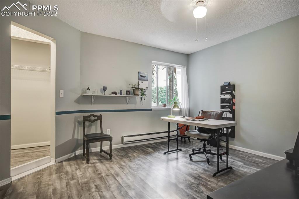 789 Alexander Road, Unit D Colorado Springs, CO 80909 - Photo 11 of 36 a view of a workspace with furniture and a window