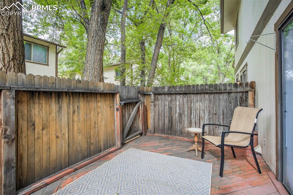 789 Alexander Road, Unit D Colorado Springs, CO 80909 - Photo 24 of 36 a backyard of a house with table and chairs