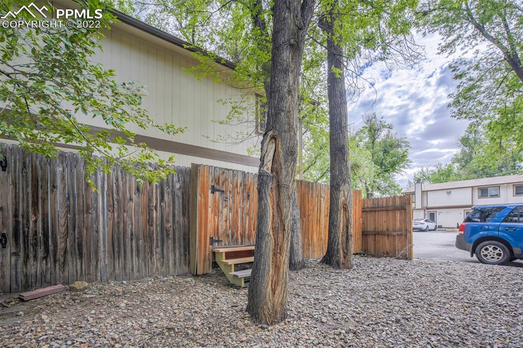 789 Alexander Road, Unit D Colorado Springs, CO 80909 - Photo 26 of 36 a view of a house with a backyard