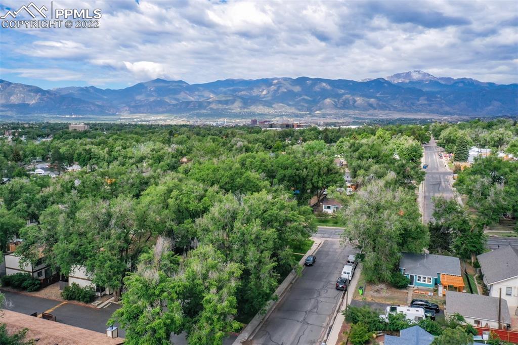 789 Alexander Road, Unit D Colorado Springs, CO 80909 - Photo 33 of 36 a view of a lush green hillside and a houses
