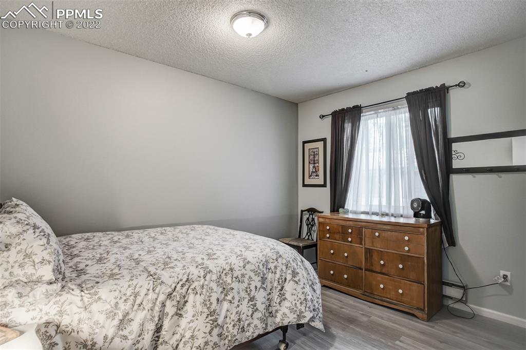 789 Alexander Road, Unit D Colorado Springs, CO 80909 - Photo 7 of 36 a bedroom with a bed and a window