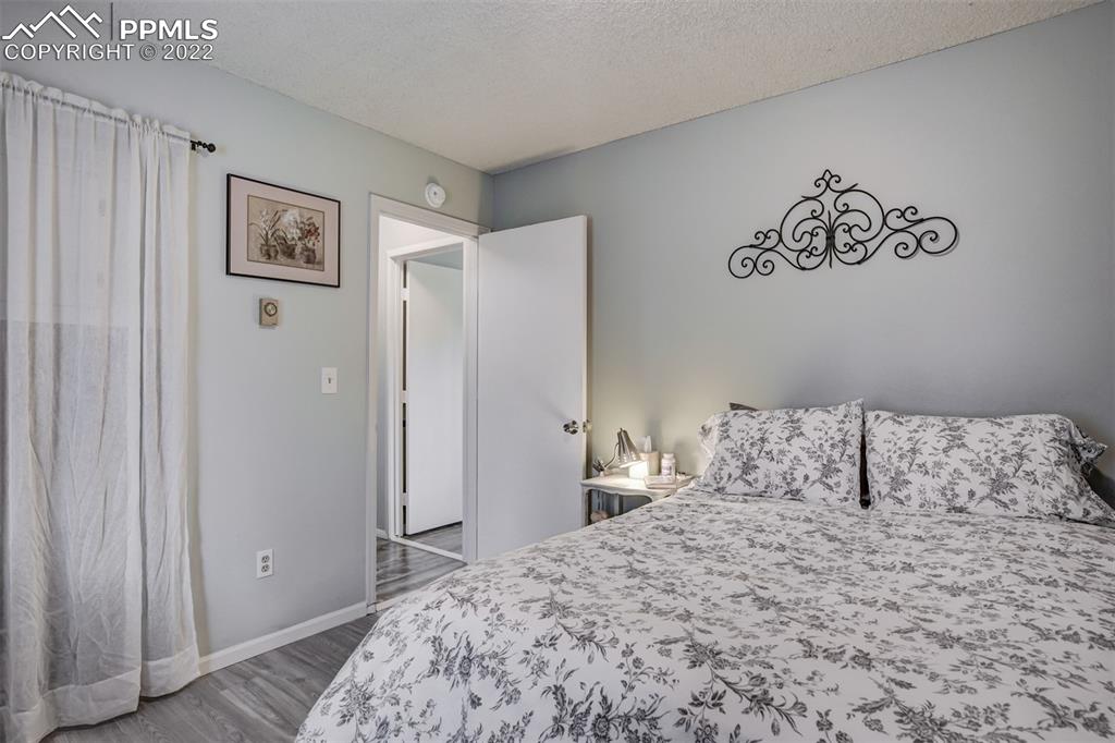 789 Alexander Road, Unit D Colorado Springs, CO 80909 - Photo 9 of 36 a bedroom with a large bed and a closet