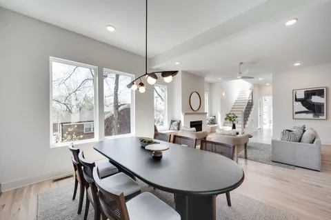 a kitchen with stainless steel appliances kitchen island hardwood floor sink and stove