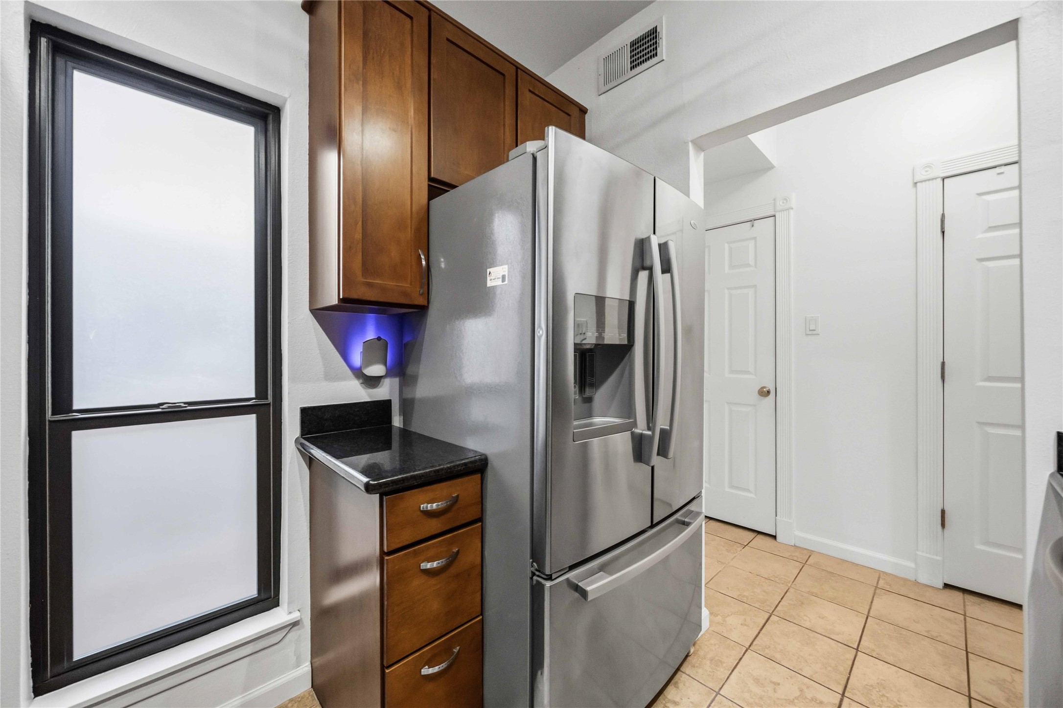 2100 Commonwealth Street, Unit C Houston, TX 77006 - Photo 12 of 25 a kitchen with stainless steel appliances granite countertop a refrigerator and a sink