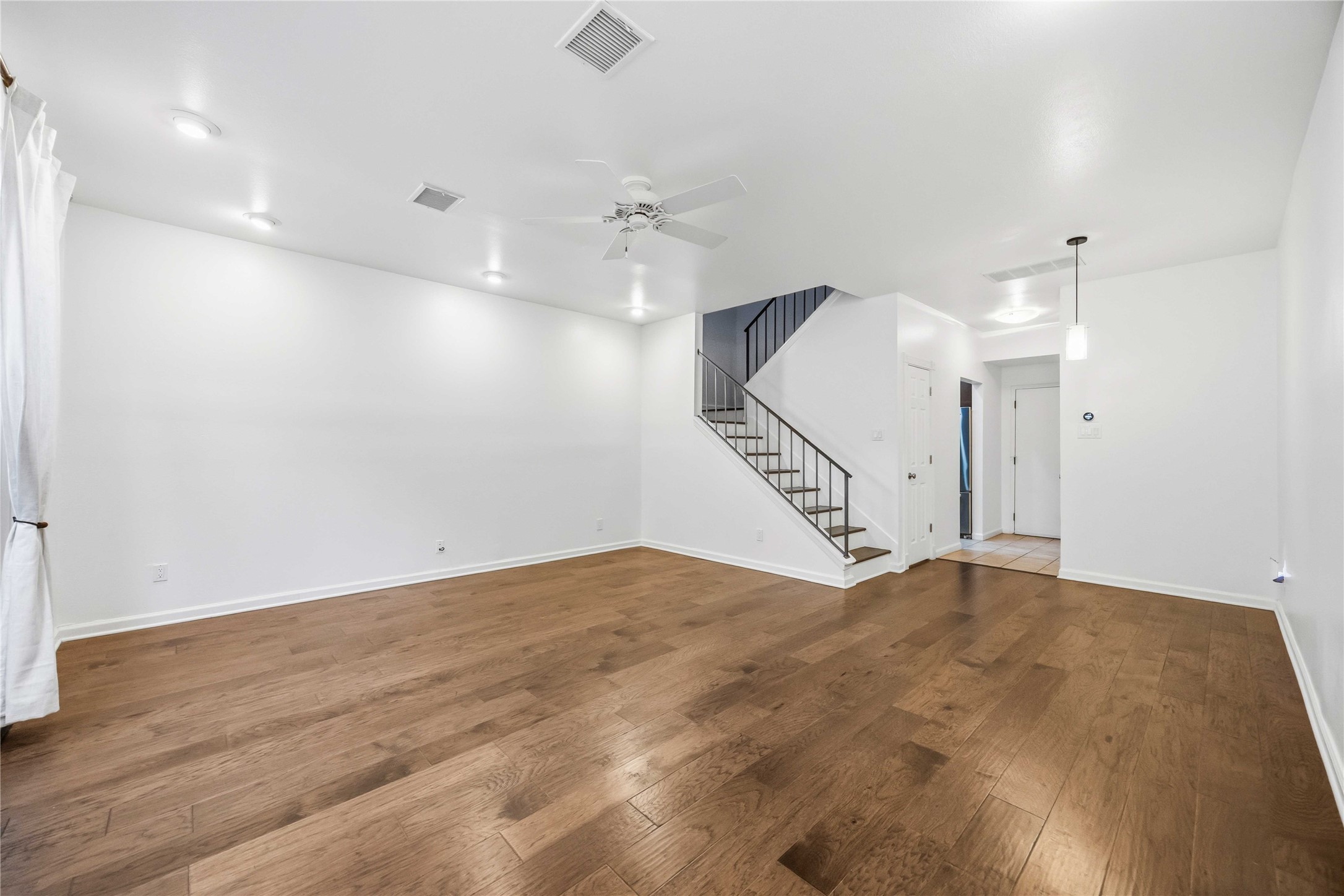 2100 Commonwealth Street, Unit C Houston, TX 77006 - Photo 5 of 25 an empty room with staircase and white walls