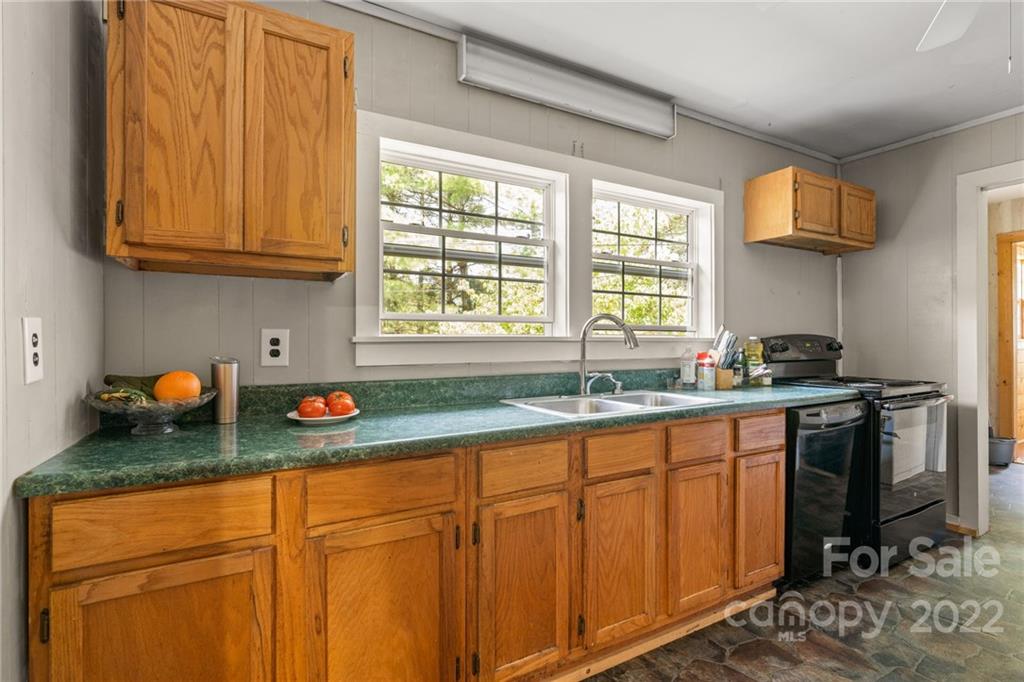 44 Jessella Drive Clyde, NC 28721 - Photo 12 of 37 a kitchen with stainless steel appliances granite countertop a sink window and cabinets
