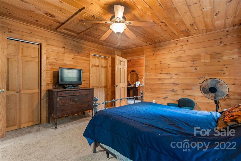 44 Jessella Drive Clyde, NC 28721 - Photo 18 of 37 a bedroom with a bed and a television