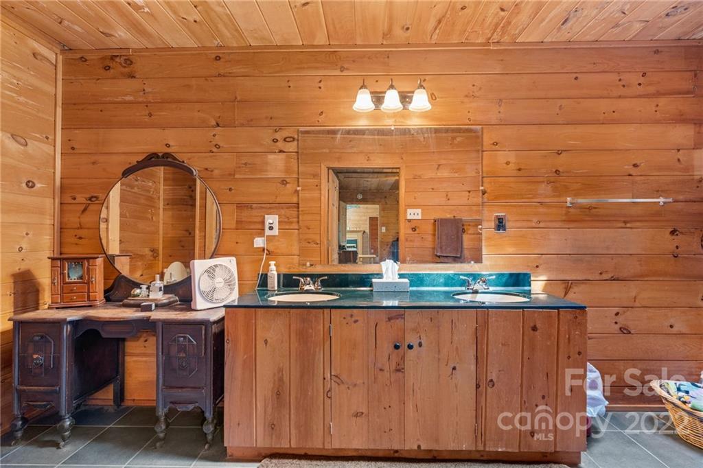 44 Jessella Drive Clyde, NC 28721 - Photo 20 of 37 a bathroom with a sink and a mirror