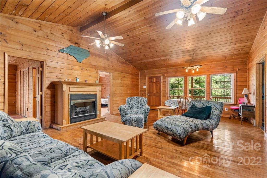 44 Jessella Drive Clyde, NC 28721 - Photo 7 of 37 a bedroom with furniture and a fireplace