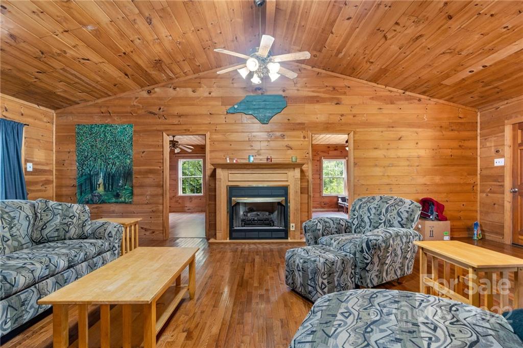 44 Jessella Drive Clyde, NC 28721 - Photo 8 of 37 a living room with furniture a fireplace and a flat screen tv