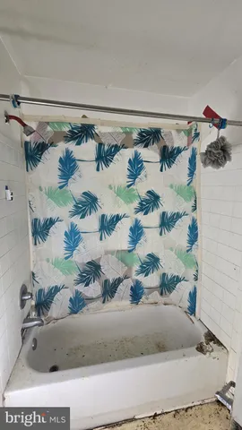 a bathroom with a granite countertop sink and a bathtub