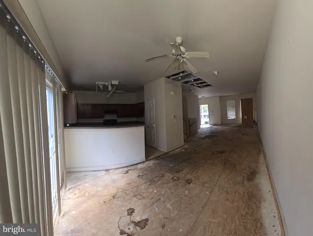 a view of a livingroom with furniture and chandelier fan