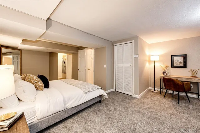 a bedroom with a bed and a table in it