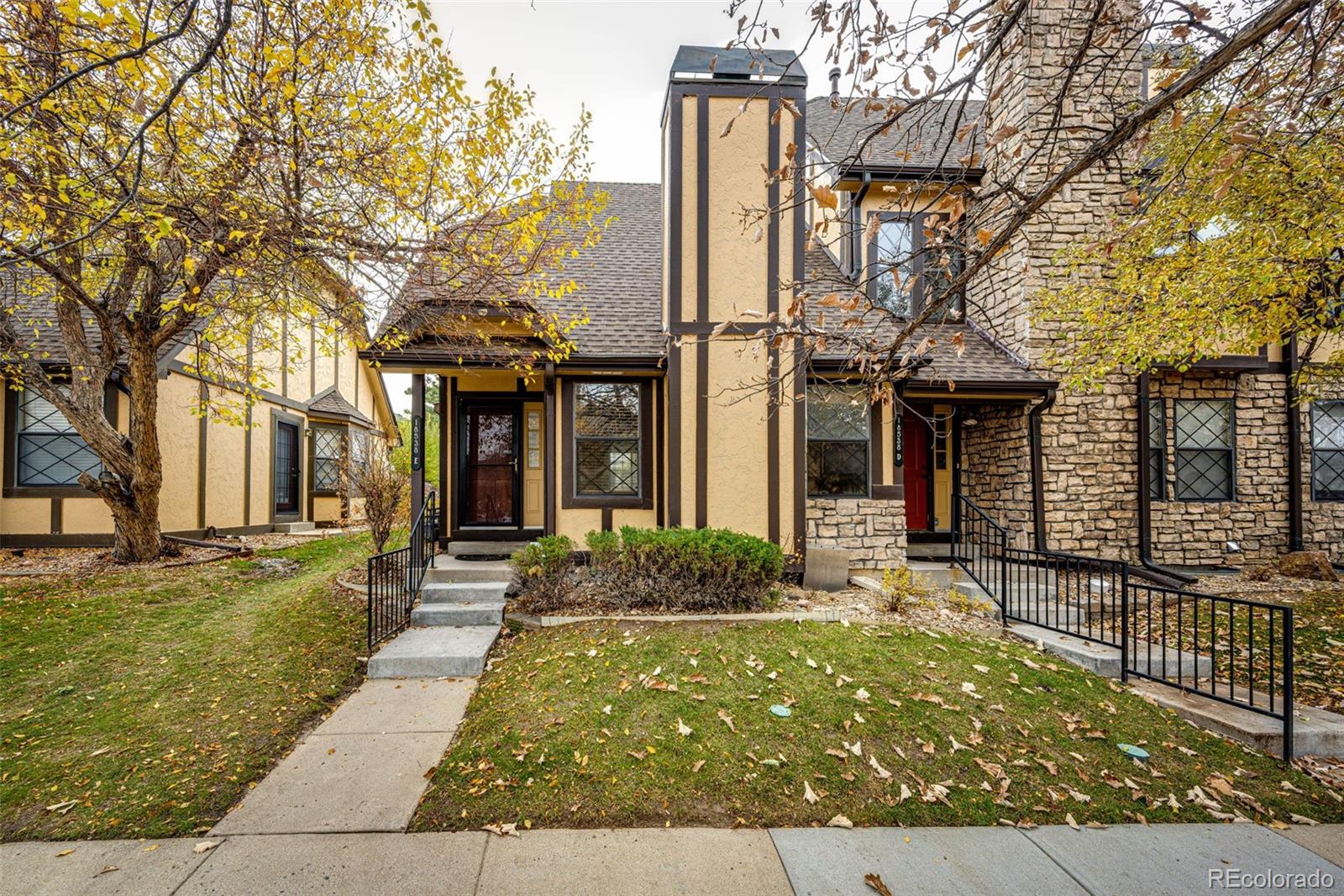18538 East Whitaker Circle, Unit E Aurora, CO 80015 - Photo 2 of 31 a front view of a house with garden