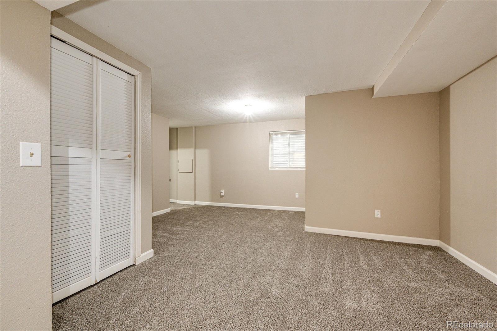 18538 East Whitaker Circle, Unit E Aurora, CO 80015 - Photo 22 of 31 an empty room with windows
