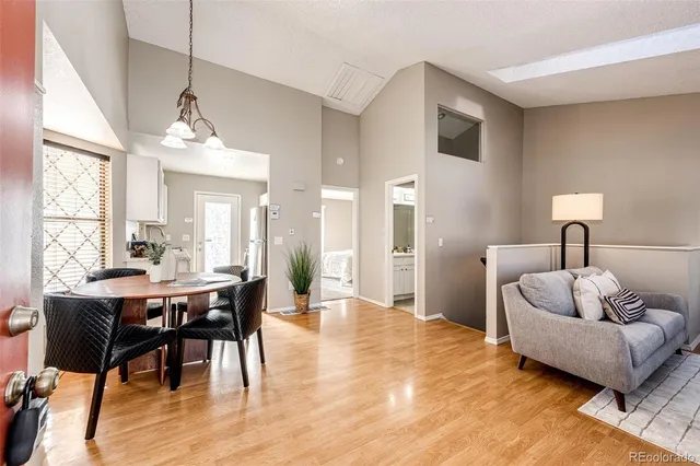 a living room with furniture and a chandelier